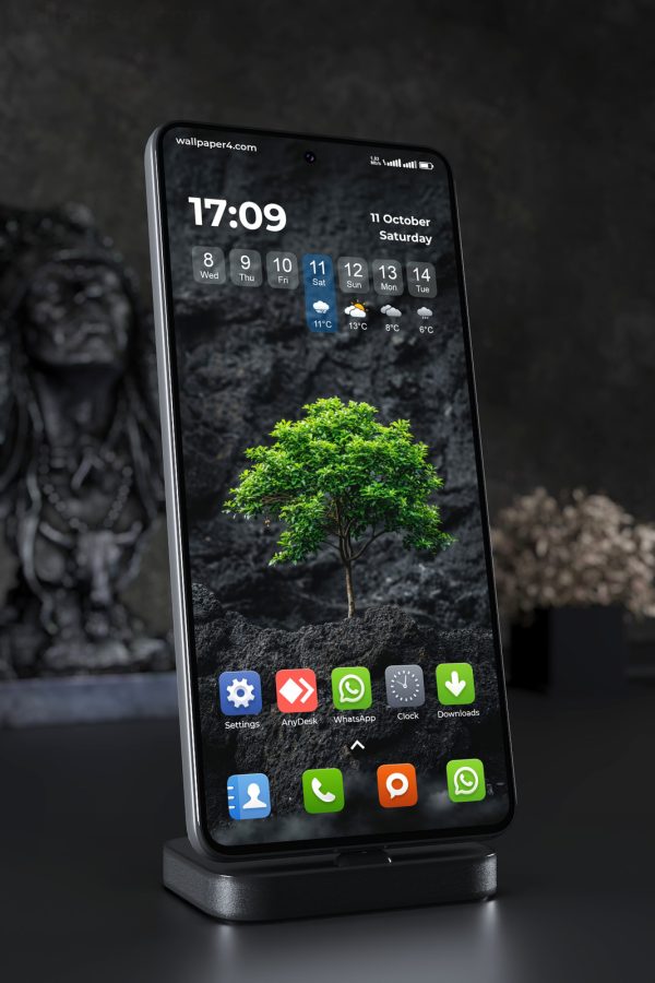 Phone Wallpaper 7544 - Vibrant Green Tree on Dark Volcanic Rocks