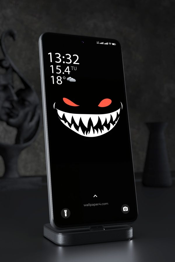 Phone Wallpaper 8117 - Sinister Red-Eyed Grin on a Black Background